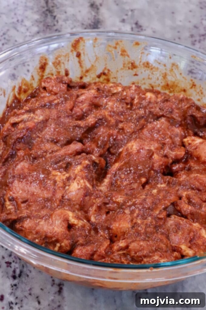 Sweet & Spicy Al Pastor Pork 4 thinly sliced pork tossed in a spicy Mexican marinade in a glass bowl