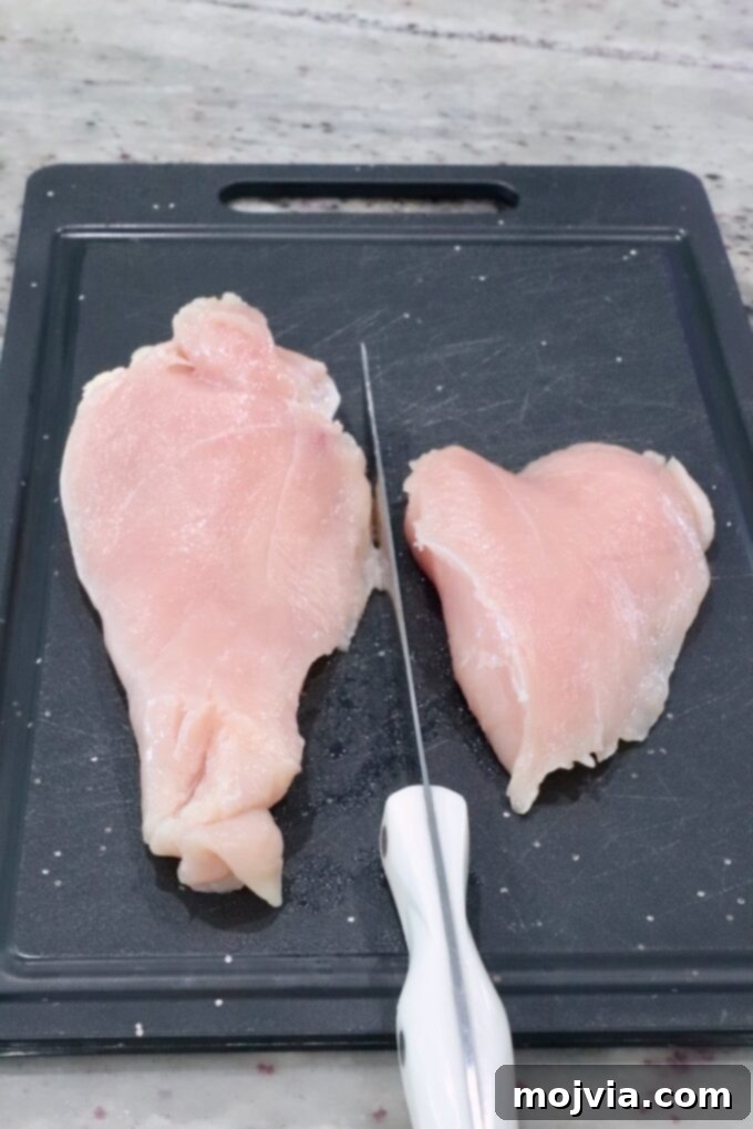 Bayou Blackened Chicken Salad 4 Chicken breast sliced lengthwise on a cutting board, ready for seasoning.