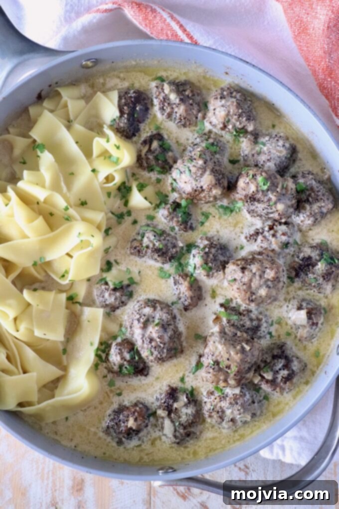 Creamy Peppercorn Meatballs 11 meatballs au poivre in a skillet with pappardelle pasta noodles