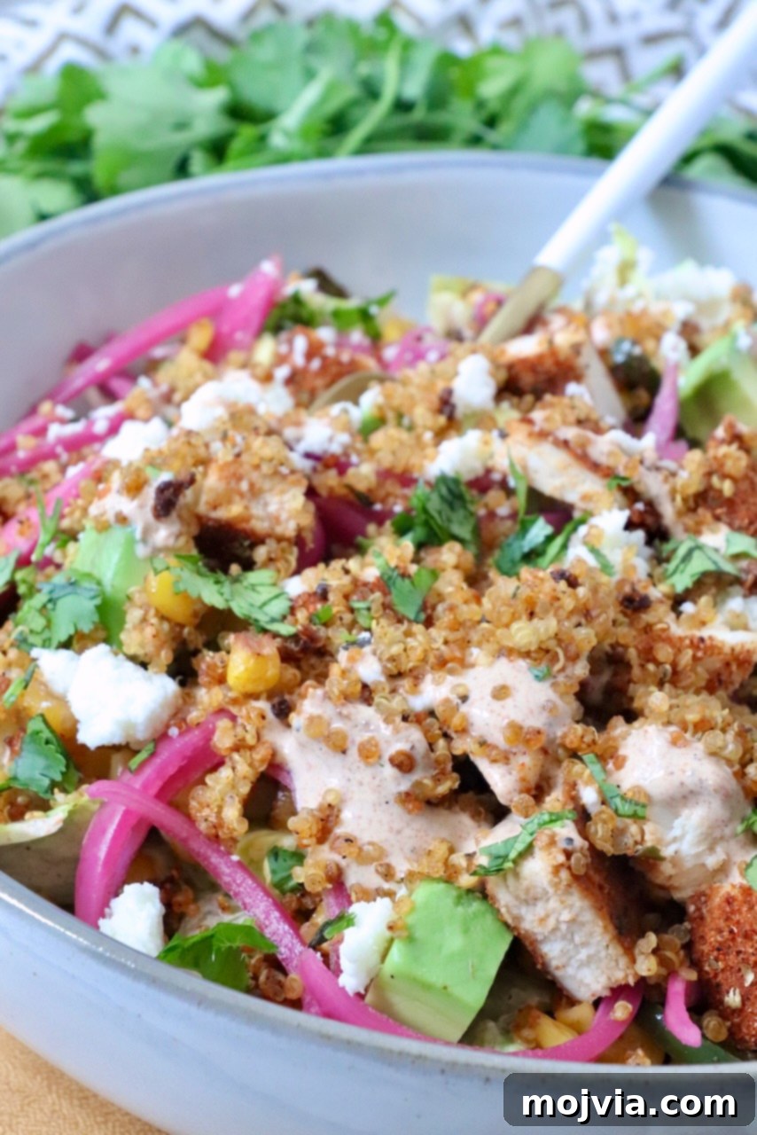 Mexican street corn bowls with cooked chicken, crispy quinoa, and pickled onions