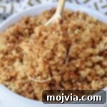 Golden Quinoa Crunch 9 A golden spoon lifting crispy quinoa from a bowl, highlighting its crunchy texture.