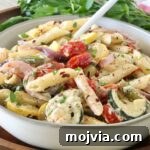 Creamy Boursin Pasta Primavera with Spring Vegetables 11 creamy pasta primavera in a bowl with a fork, with fresh parsley in the background