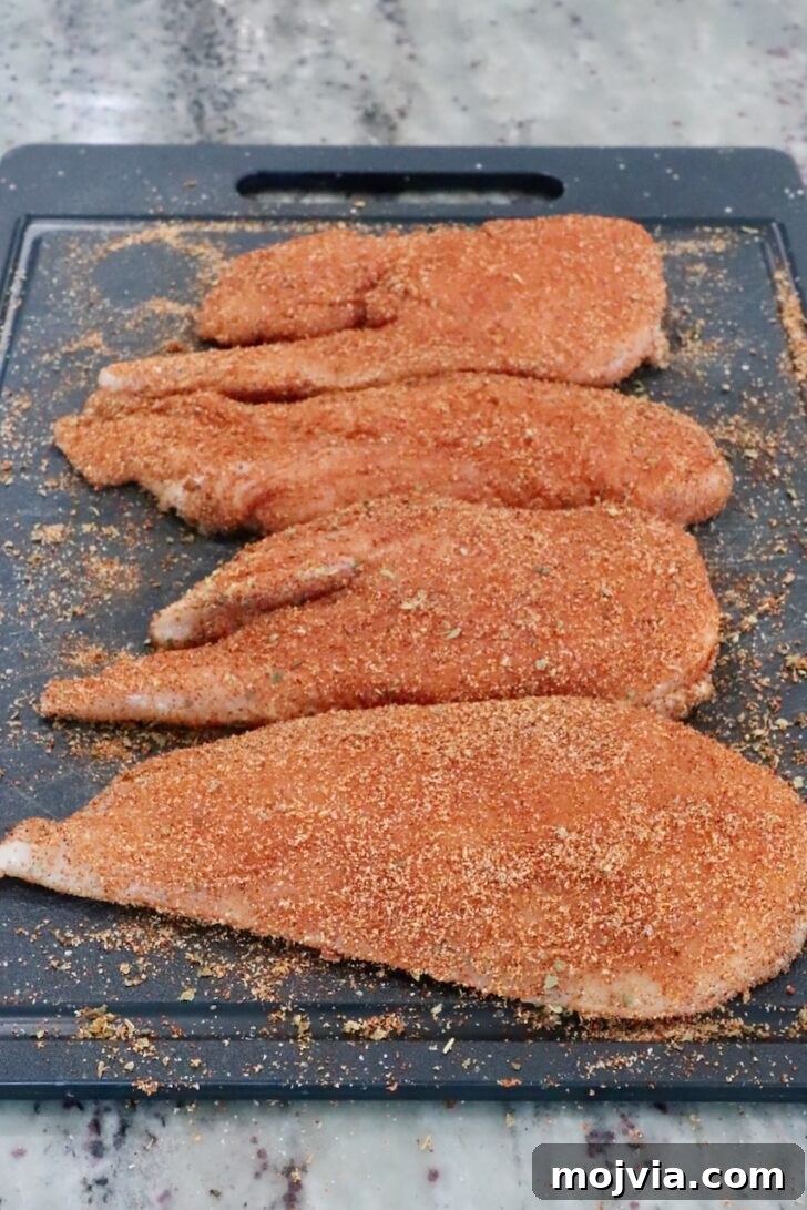 Chipotle Honey Chicken Tacos Made in the Air Fryer 6 seasoned raw chicken breasts on a cutting board