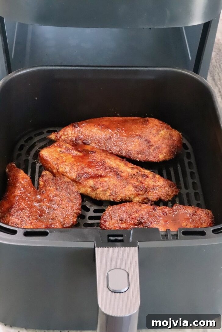 Chipotle Honey Chicken Tacos Made in the Air Fryer 9 cooked chipotle honey chicken breasts in a an air fryer basket