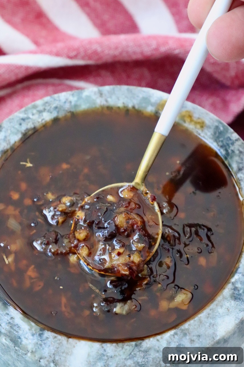 Calabrian Chili Crisp: Spicy Oil Recipe & Flavor Uses 2 Calabrian chili crisp in a bowl with a spoon