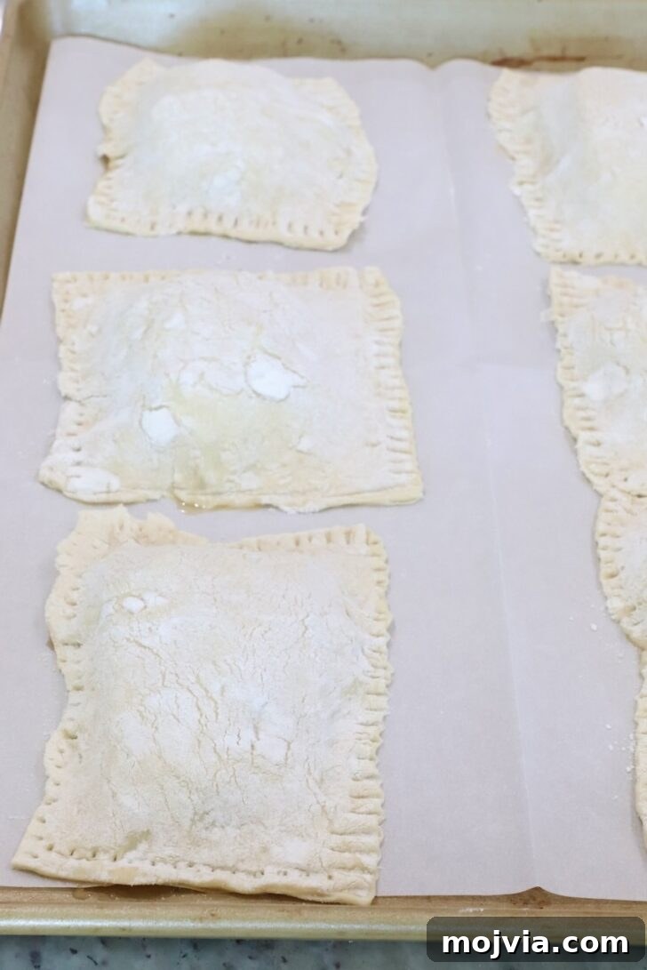 Gorgonzola and Pear Tart Recipe: Savory-Sweet Rustic Tart 12 unbaked tarts on a parchment-lined baking sheet