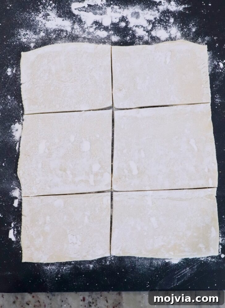 Gorgonzola and Pear Tart Recipe: Savory-Sweet Rustic Tart 6 sheet of puff pastry dough cut into 6 rectangles on a dark cutting board