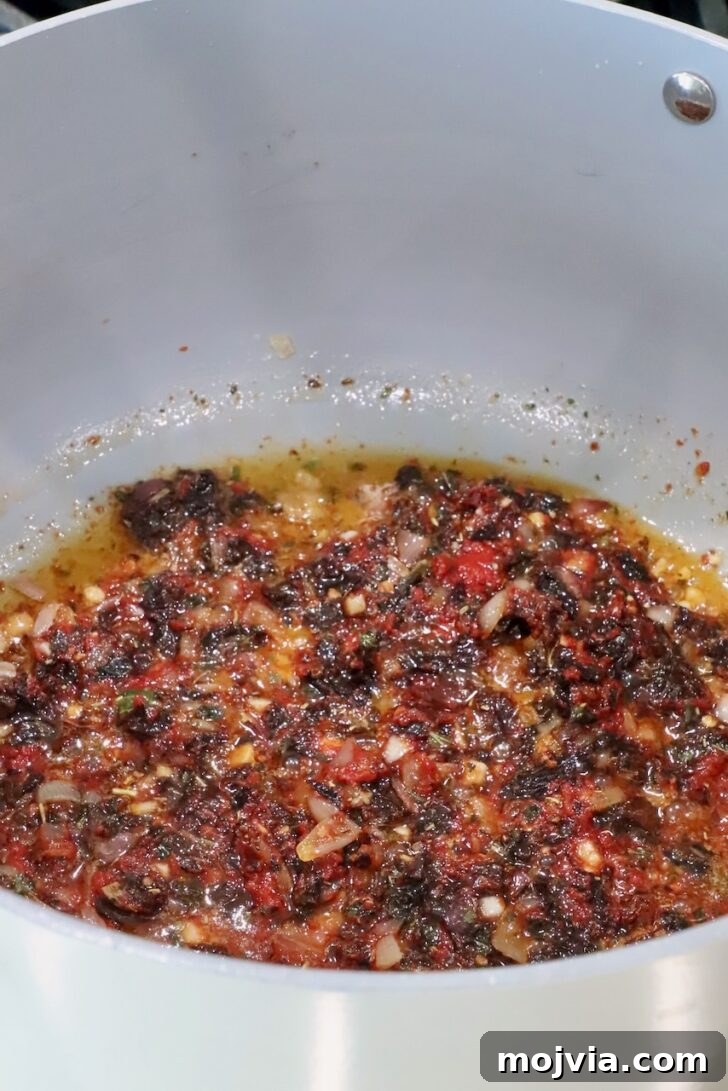 Creamy Tuscan Chicken Pasta Recipe with Sun-Dried Tomatoes 8 sun dried tomatoes mixed with melted butter and seasonings in a saucepan