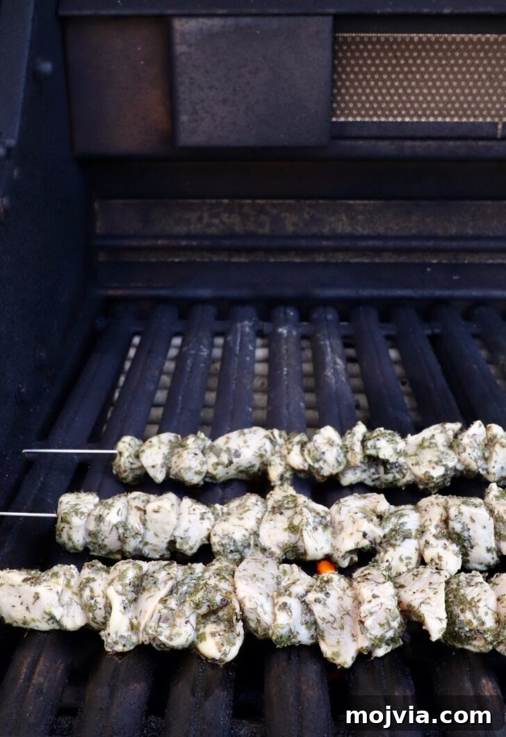 Authentic Greek Souvlaki Recipe: How to Make Classic Meat Skewers 8 raw chicken skewers on a grill