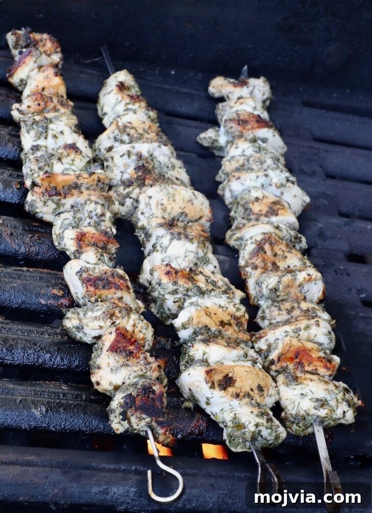 Authentic Greek Souvlaki Recipe: How to Make Classic Meat Skewers 9 grilled chicken breast skewers on a grill