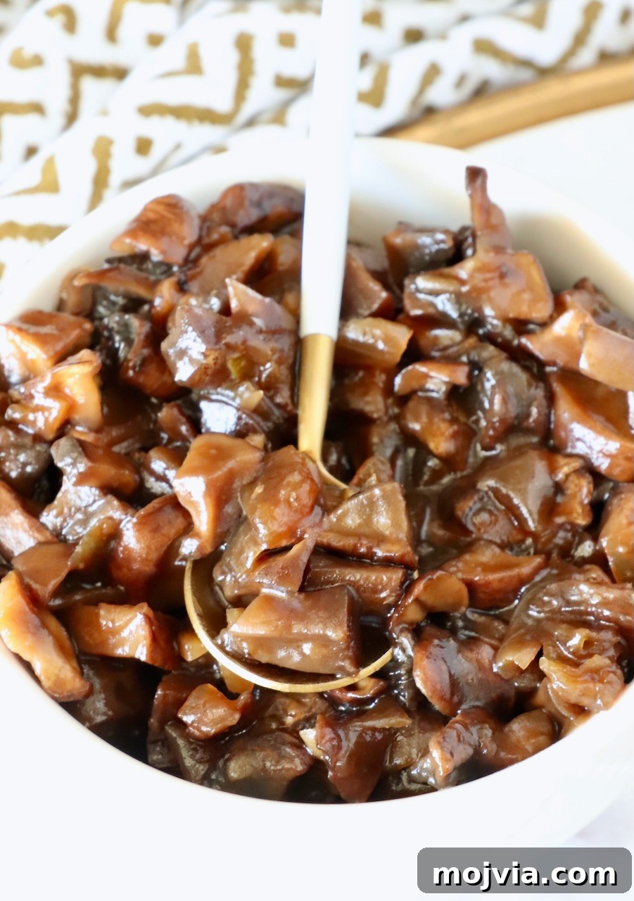 Savory Mushroom Jam Recipe for Spreading and Cooking 2 mushroom jam in a white bowl with a gold and white spoon