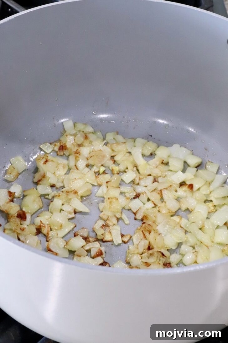 Savory Mushroom Jam Recipe for Spreading and Cooking 6 cooked, diced onions in a large pot on the stove
