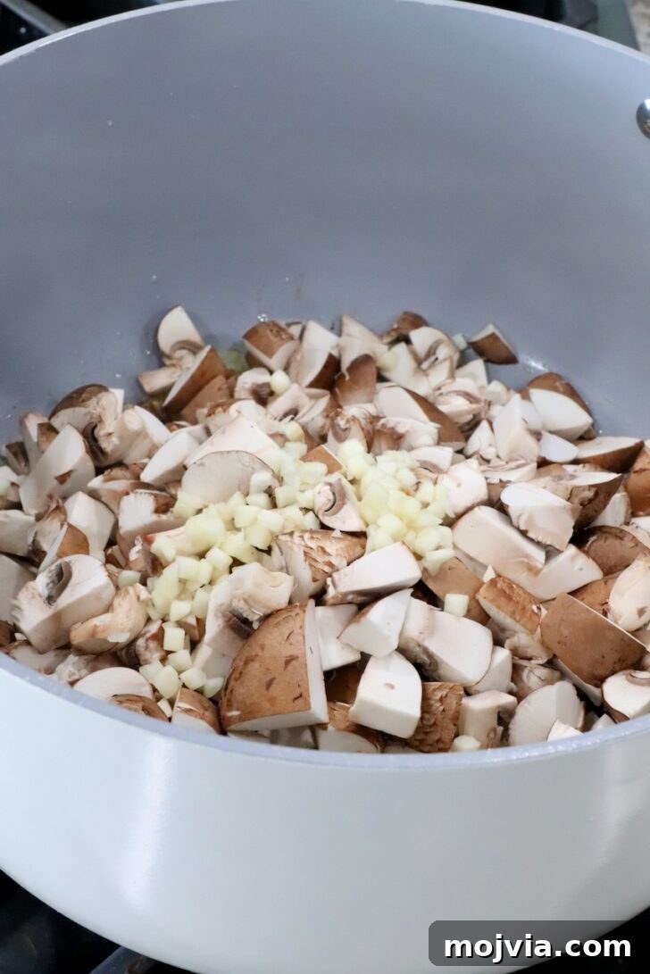 Savory Mushroom Jam Recipe for Spreading and Cooking 7 diced mushrooms and minced garlic in a pot on the stove