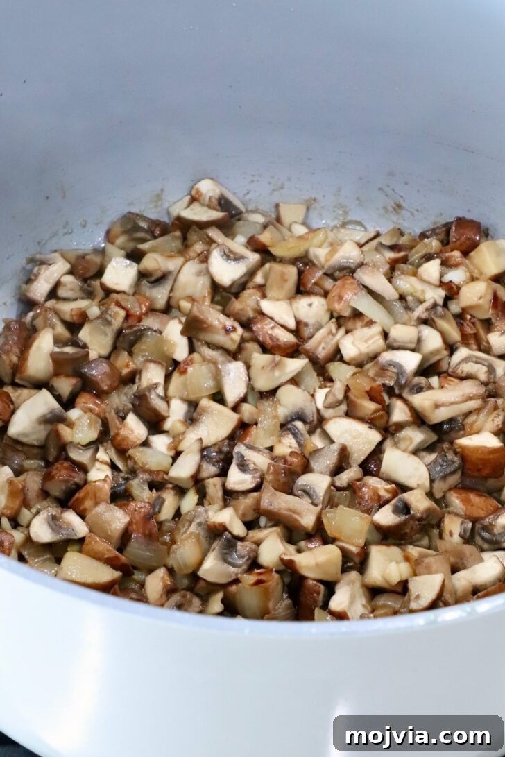 Savory Mushroom Jam Recipe for Spreading and Cooking 8 cooked diced mushrooms in a pot on the stove