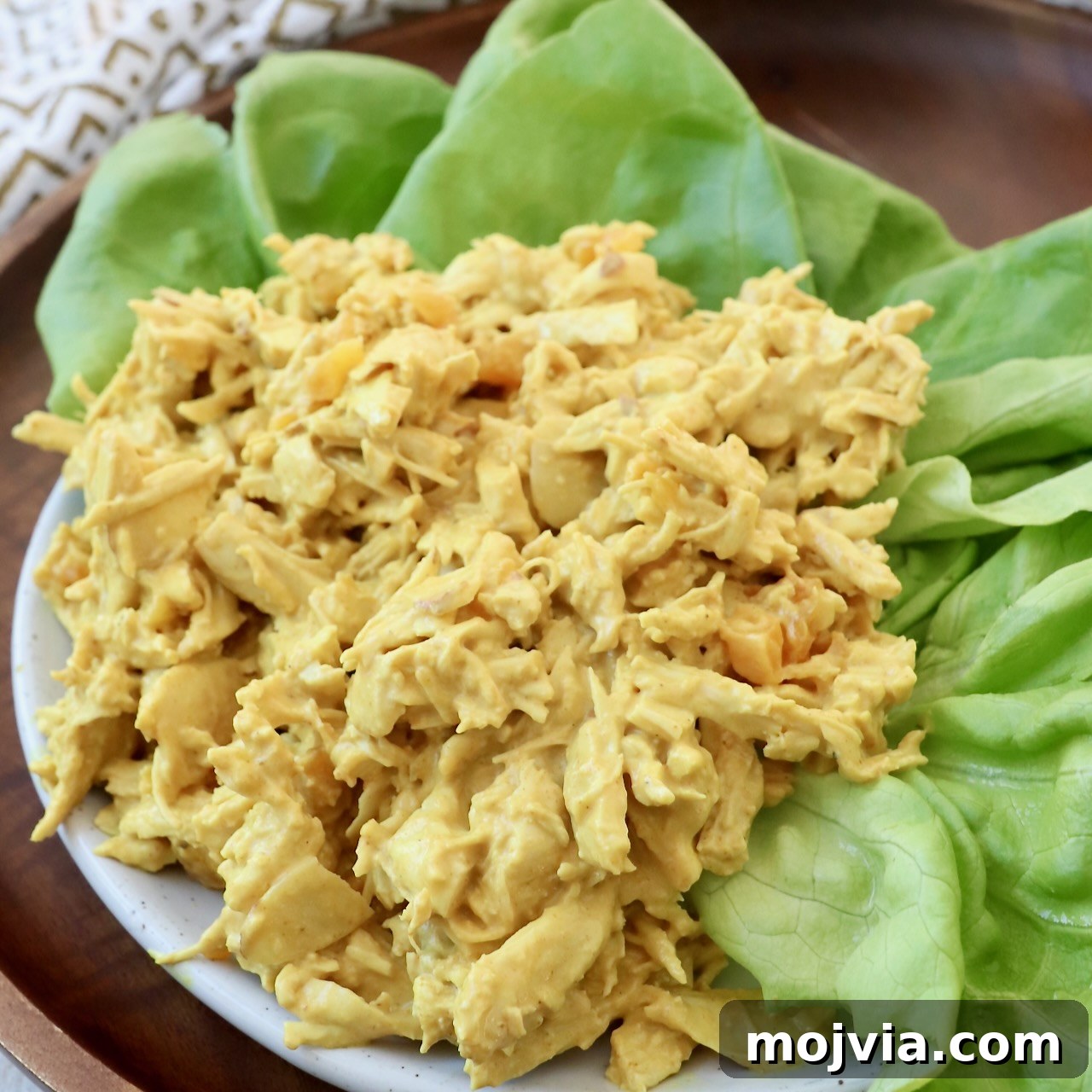 coronation chicken on plate with leaves of lettuce