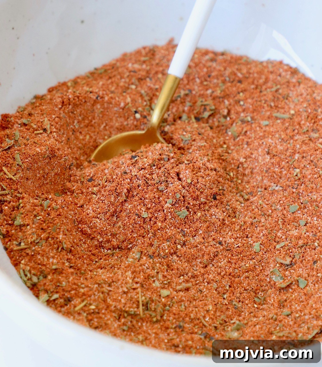blackened seasoning in a white bowl with a spoon