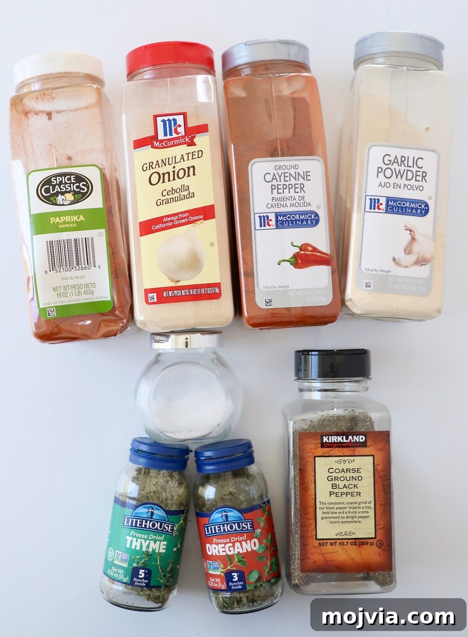 dried herbs and spices in plastic containers on a white surface