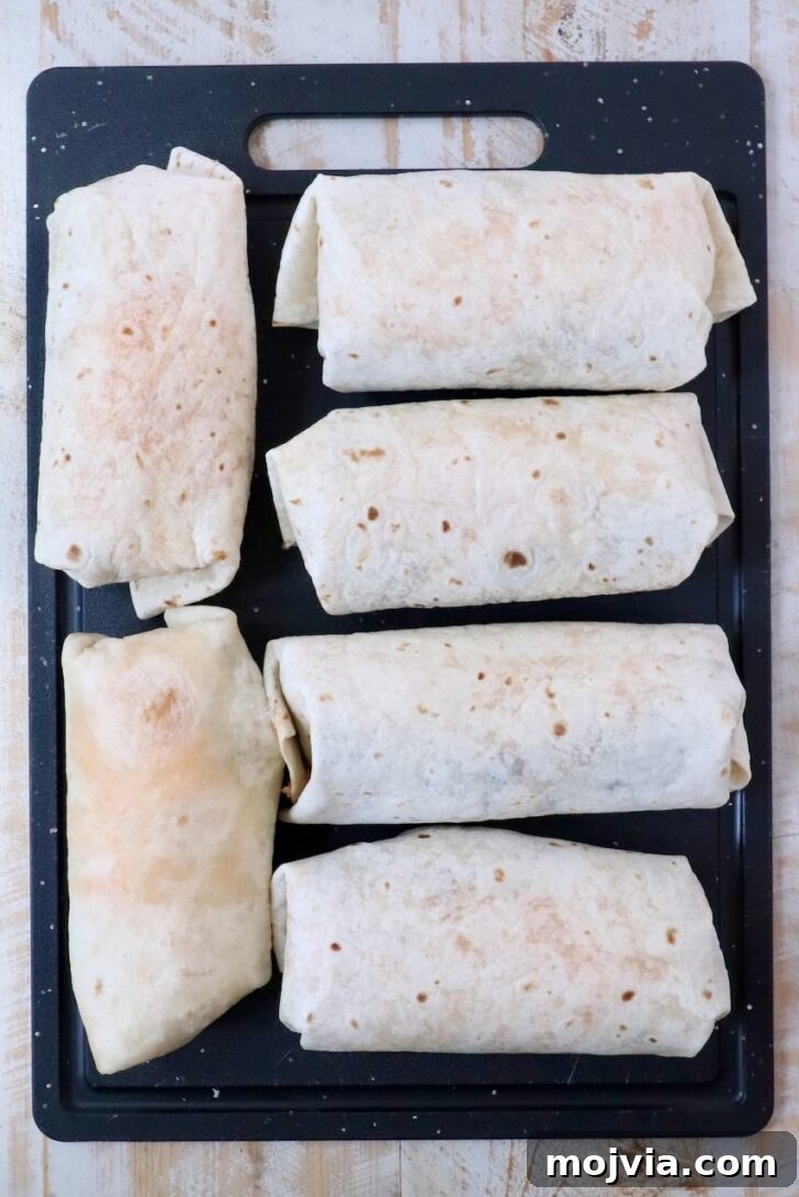 Melted Cheese, Beans & Rice Burrito Recipe for Weeknights 13 six prepared burritos on a cutting board