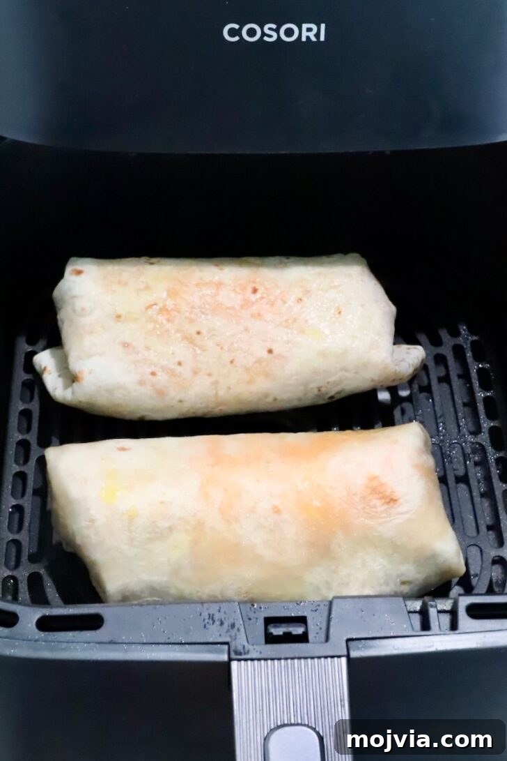 Melted Cheese, Beans & Rice Burrito Recipe for Weeknights 14 two burritos in an air fryer basket