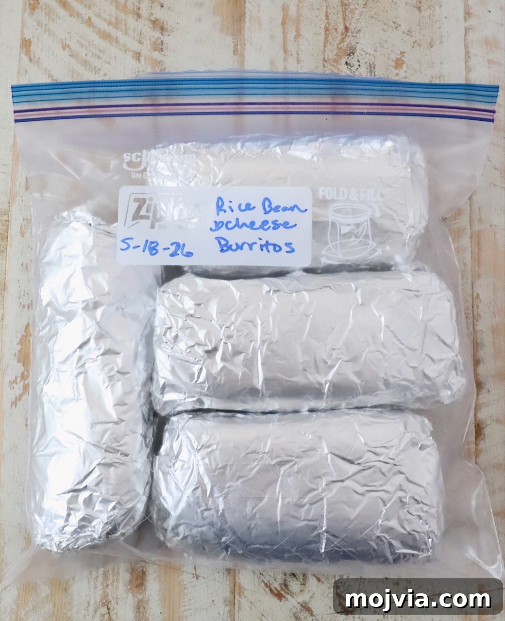 Melted Cheese, Beans & Rice Burrito Recipe for Weeknights 16 burritos wrapped in foil in a plastic zipper bag