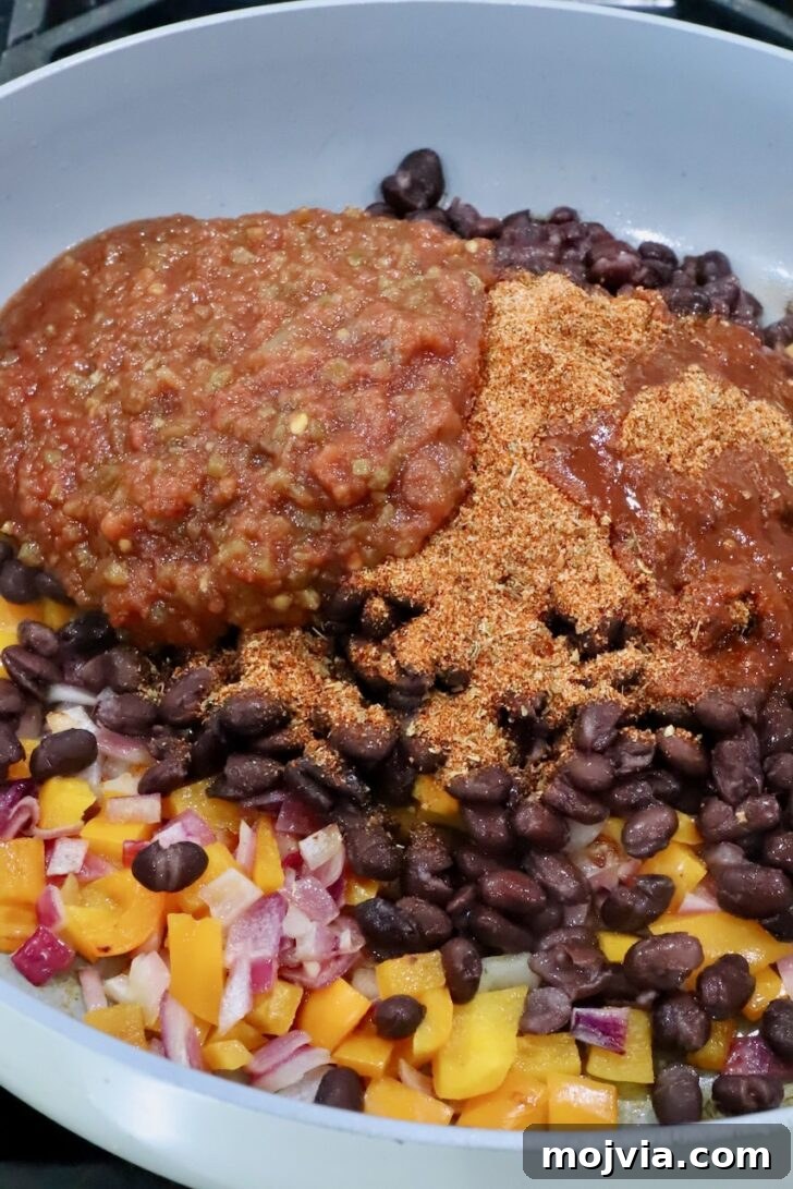 Melted Cheese, Beans & Rice Burrito Recipe for Weeknights 6 diced bell pepper, onion, black beans, salsa, and taco seasoning in a skillet