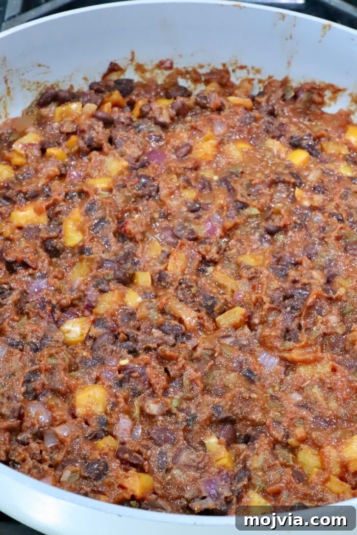 Melted Cheese, Beans & Rice Burrito Recipe for Weeknights 8 bean burrito filling in a skillet