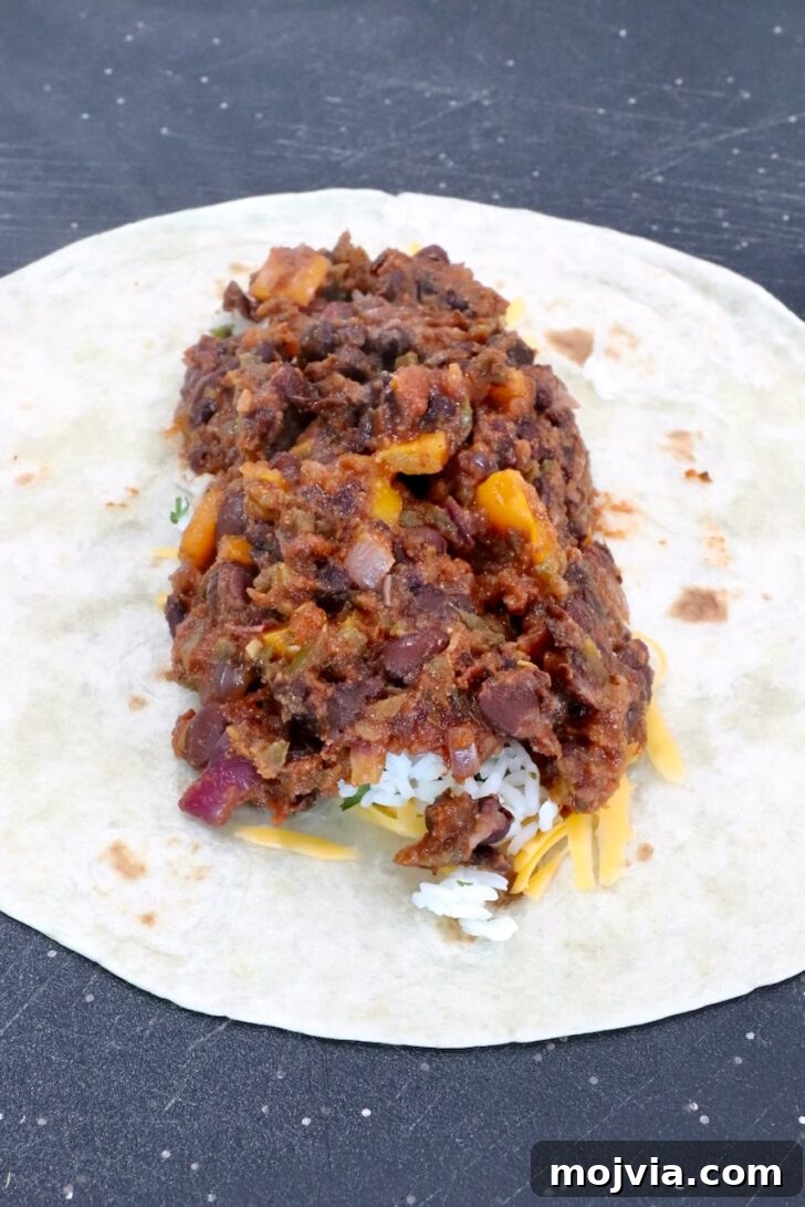 Melted Cheese, Beans & Rice Burrito Recipe for Weeknights 10 bean filling in the middle of a tortilla