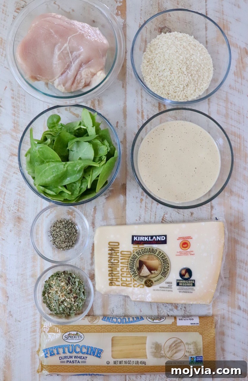 Creamy Chicken Caesar Pasta Recipe for Weeknight Dinners 5 ingredients for chicken caesar pasta on a white wood board