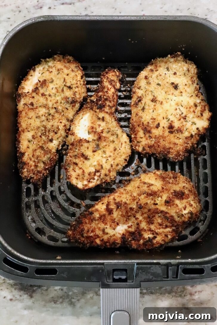 Creamy Chicken Caesar Pasta Recipe for Weeknight Dinners 9 cooked breaded chicken breasts in an air fryer basket