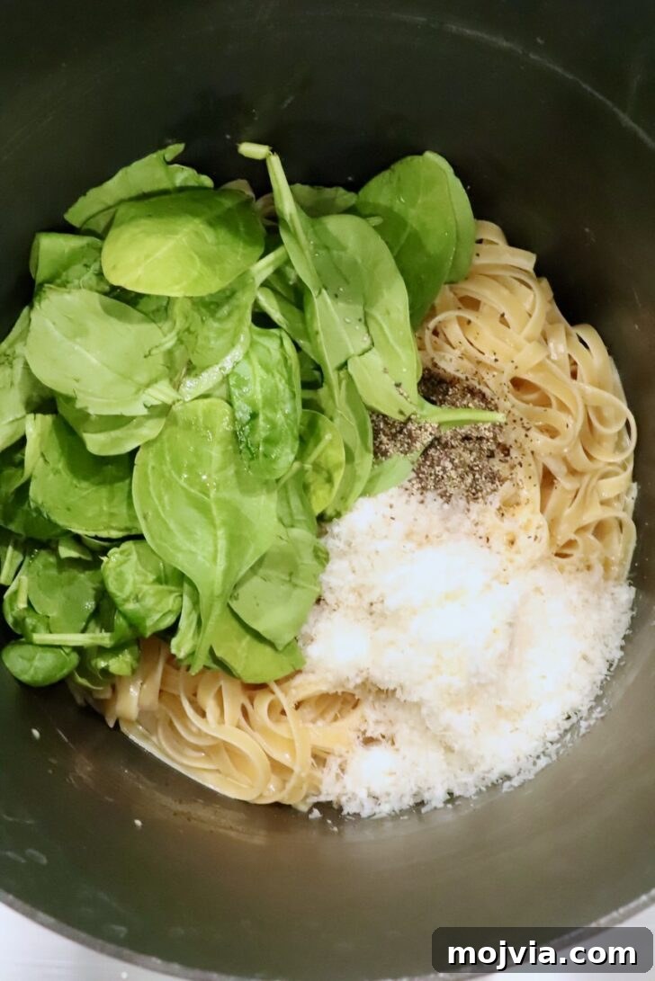 Creamy Chicken Caesar Pasta Recipe for Weeknight Dinners 10 spinach, noodles, parmesan cheese, and black pepper in a large pot
