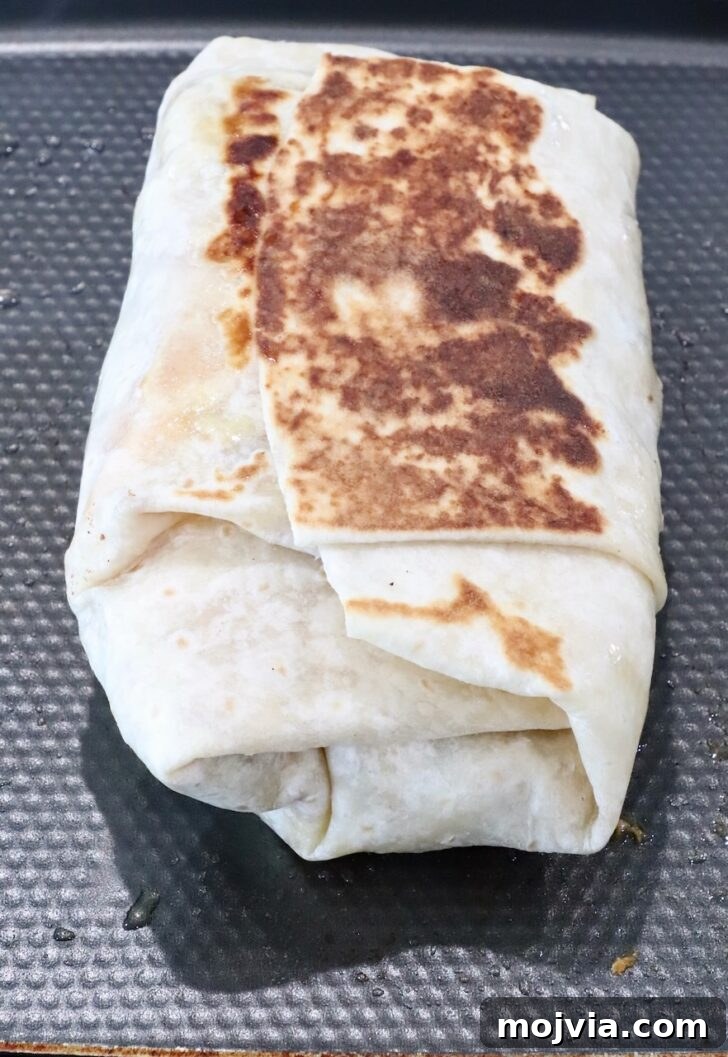 Authentic California Burrito Recipe with Carne Asada and Fries 10 crispy toasted burrito on a griddle pan