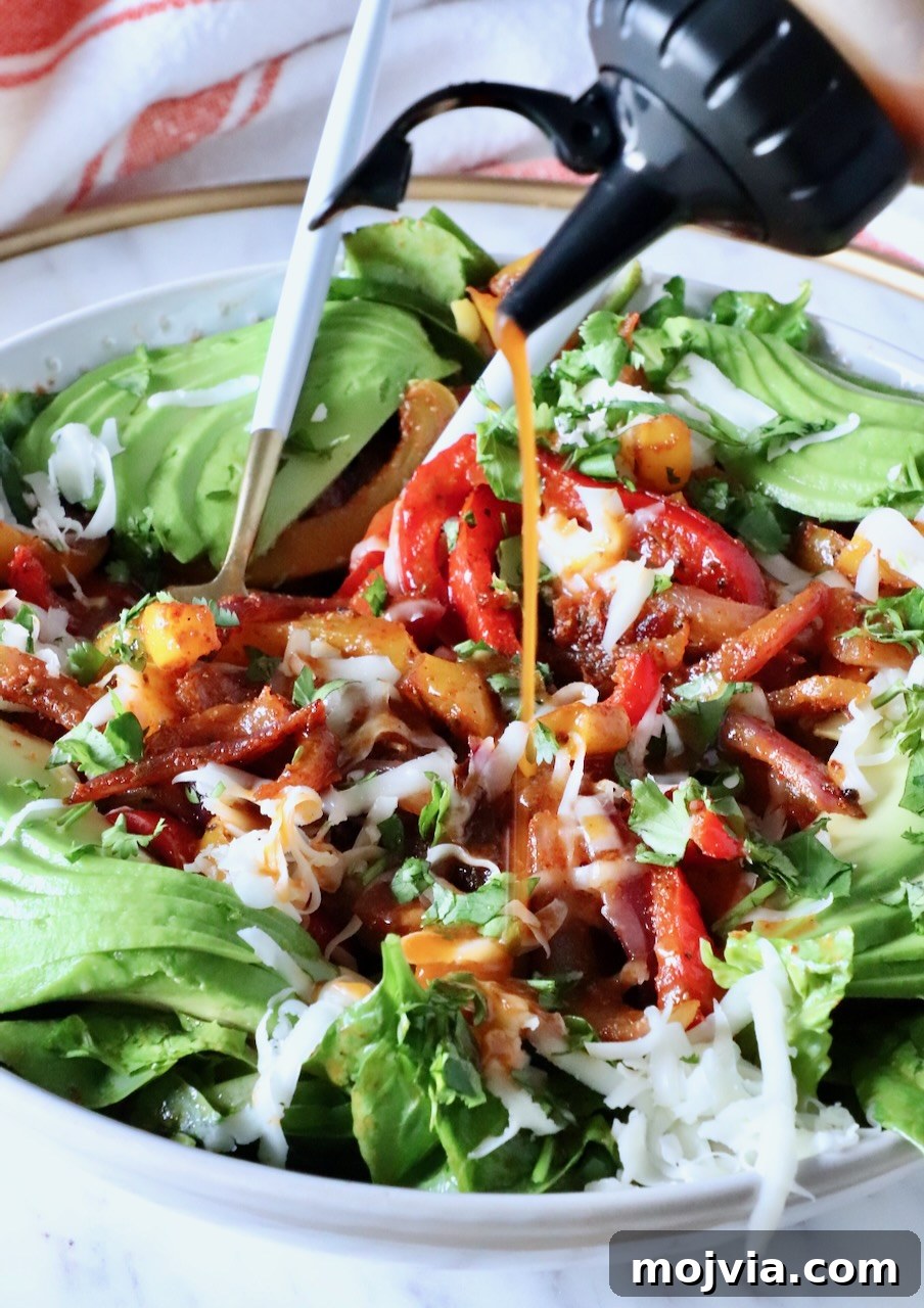 Smoky Chipotle Salad with Avocado and Corn 6 chipotle vinaigrette dressing poured over a salad in a bowl