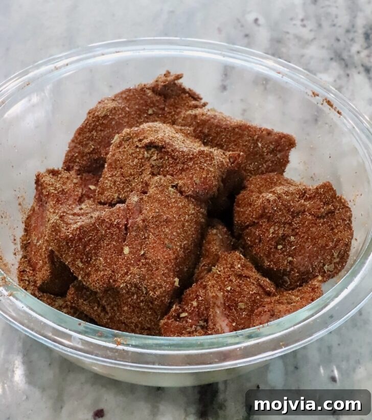 Instant Pot Beef Barbacoa: Tender Mexican Shredded Beef 6 seasoned chunks of beef in a glass bowl