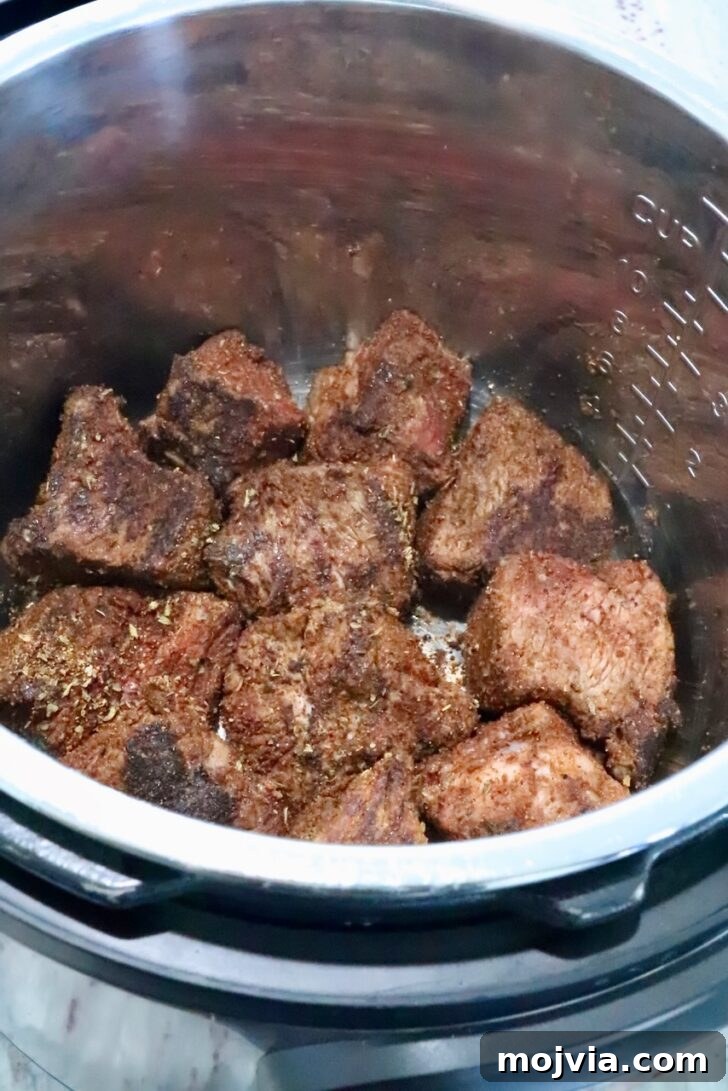 Instant Pot Beef Barbacoa: Tender Mexican Shredded Beef 7 seasoned, seared pieces of beef in an instant pot