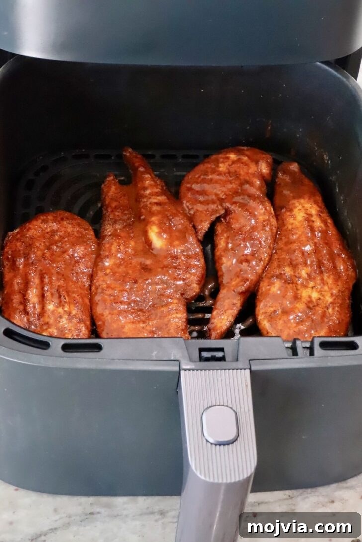 Spicy Buffalo Chicken Salad with Blue Cheese Dressing 7 cooked chicken breasts brushed with buffalo sauce in an air fryer basket