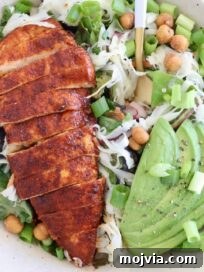 Spicy Buffalo Chicken Salad with Blue Cheese Dressing 9 sliced buffalo chicken on top of a salad with sliced avocado