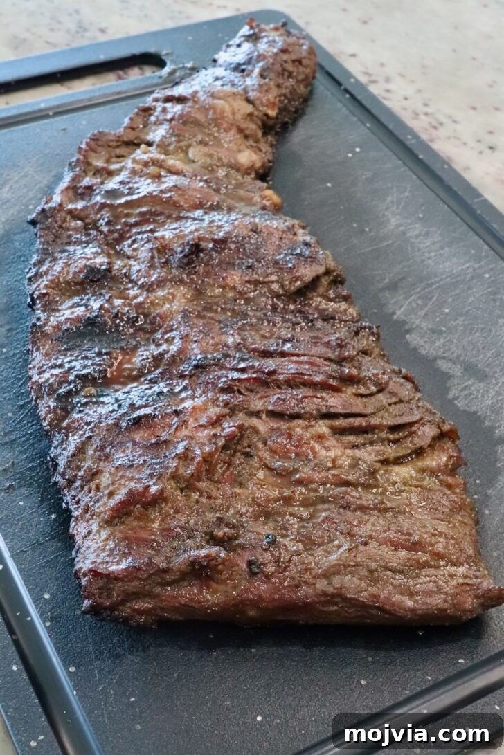 Authentic Jamaican Jerk Steak Recipe 8 grilled skirt steak resting on a cutting board
