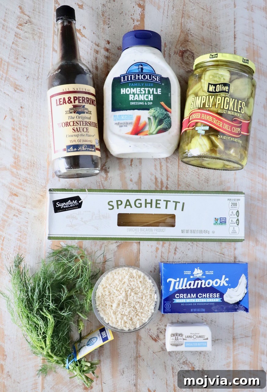 Creamy Dill-Pickle Pasta with Tangy Sauce 5 ingredients for pickle pasta with a creamy sauce on a white wood table