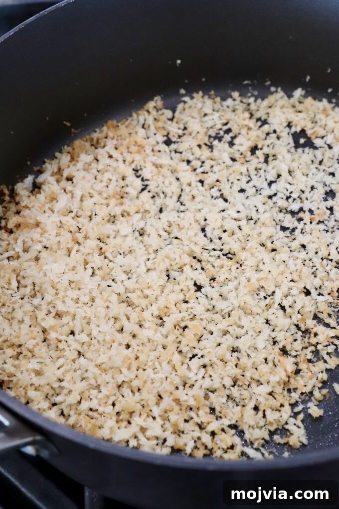 Creamy Dill-Pickle Pasta with Tangy Sauce 8 toasted breadcrumbs in skillet on stove
