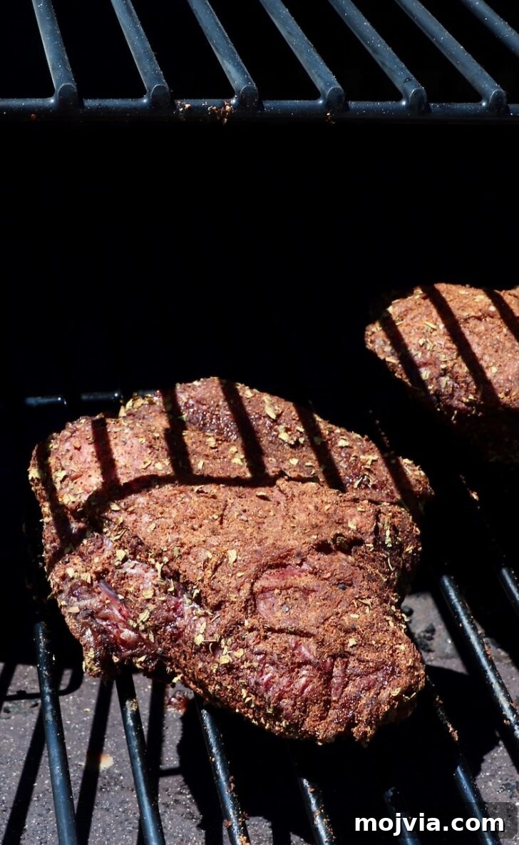 Tender Smoked Beef Cheek Barbacoa Recipe 6 seasoned beef cheeks on a smoker
