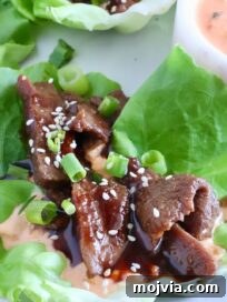 Korean Beef Bulgogi Lettuce Wraps Recipe 11 korean bbq sliced beef in a lettuce wrap with a creamy gochujang sauce on a plate